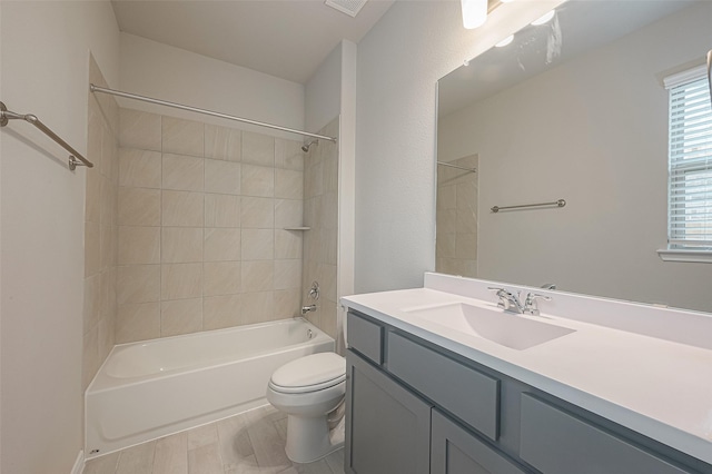 full bathroom with tiled shower / bath combo, toilet, and vanity