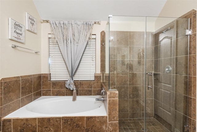 bathroom with lofted ceiling and shower with separate bathtub