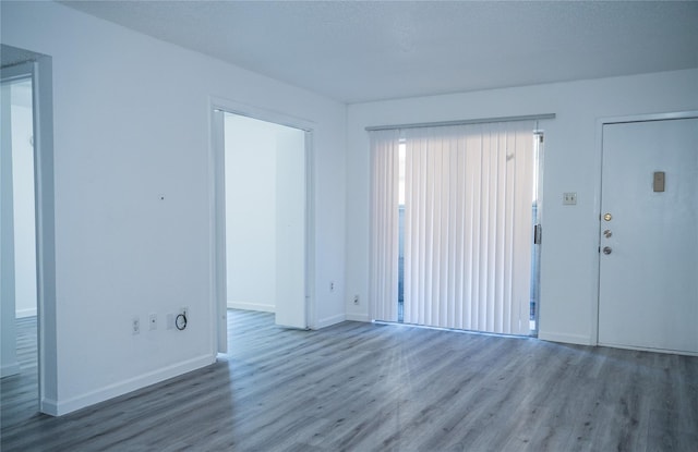 unfurnished room featuring hardwood / wood-style floors and a textured ceiling