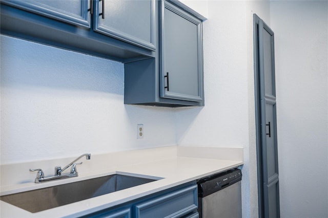 kitchen featuring dishwasher, blue cabinets, and sink