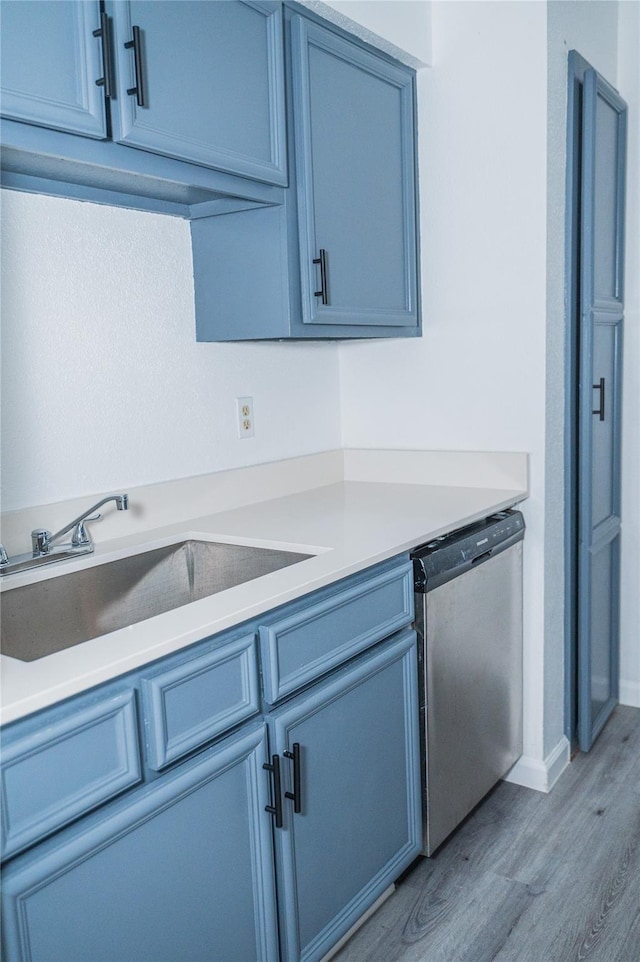 kitchen with dishwasher, light wood-type flooring, and sink