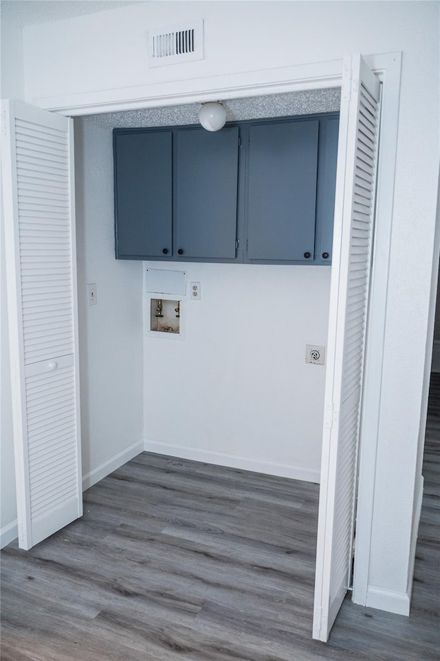 clothes washing area with hookup for a washing machine, dark wood-type flooring, and cabinets