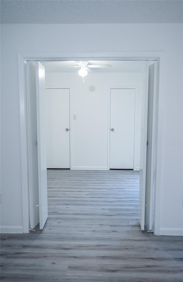 corridor with light hardwood / wood-style flooring