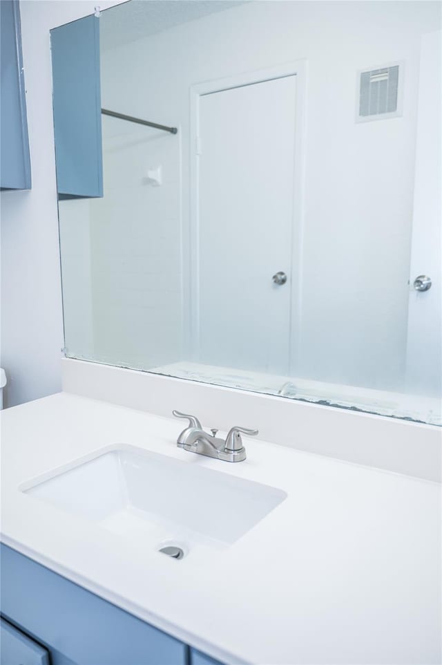 bathroom with a shower and vanity