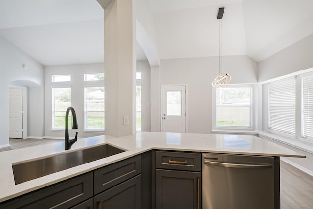 kitchen with dishwasher, sink, hanging light fixtures, kitchen peninsula, and vaulted ceiling