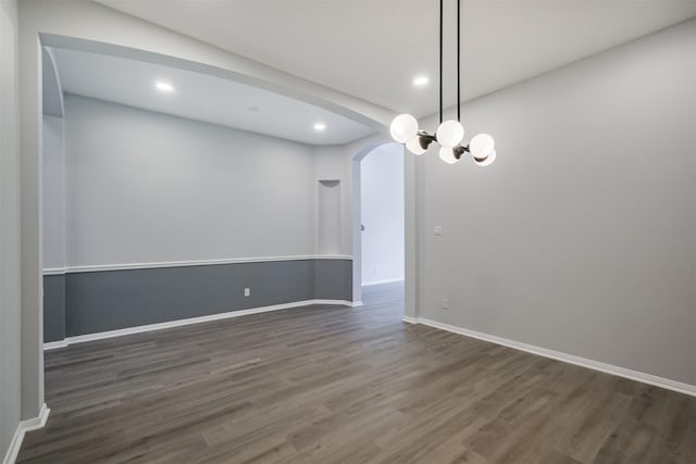 empty room with dark hardwood / wood-style flooring