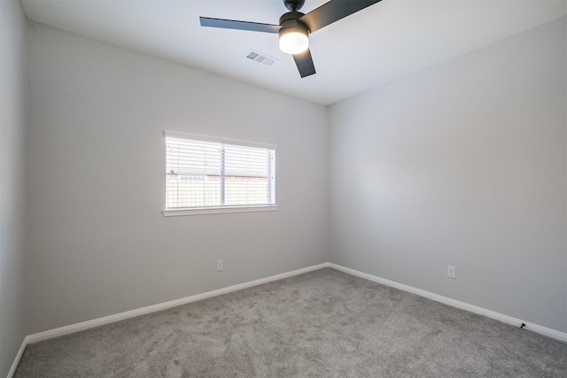 empty room featuring light colored carpet and ceiling fan