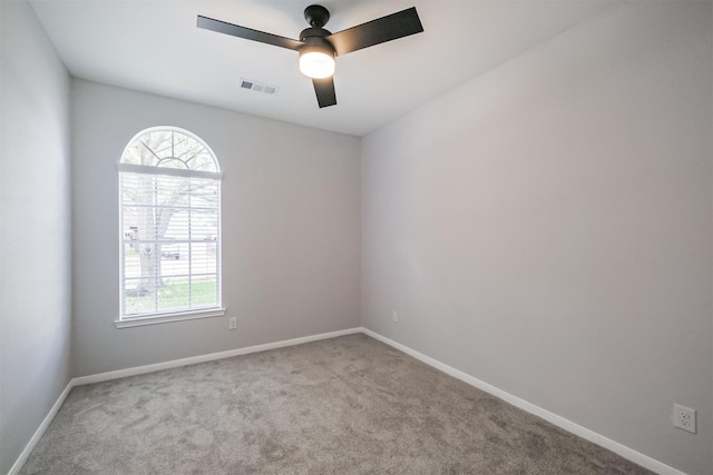 carpeted empty room featuring ceiling fan