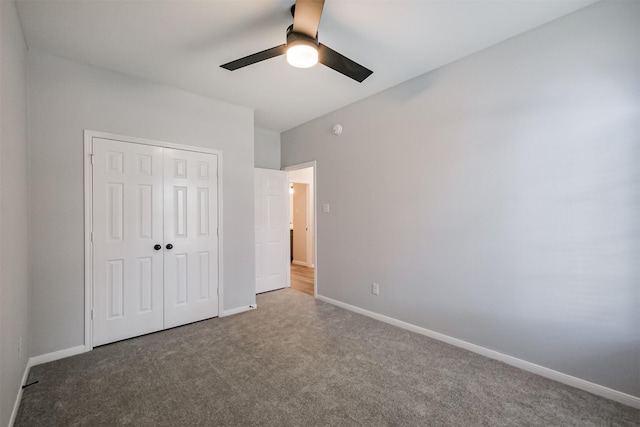 unfurnished bedroom featuring ceiling fan, a closet, and carpet