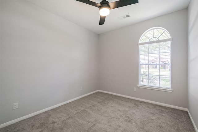 empty room with light colored carpet and ceiling fan