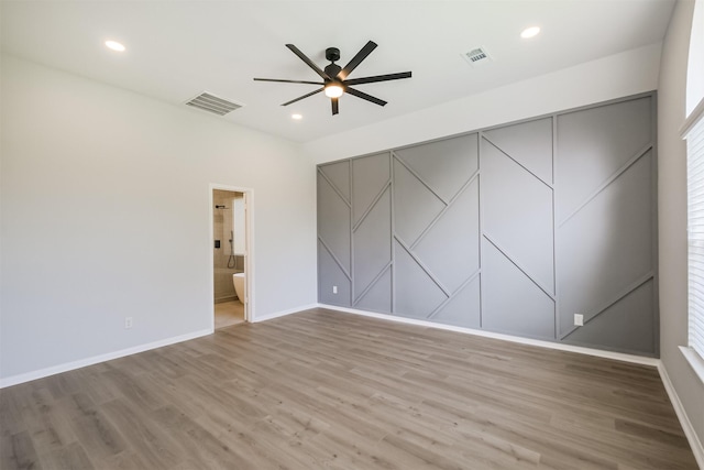 unfurnished room featuring hardwood / wood-style floors and ceiling fan