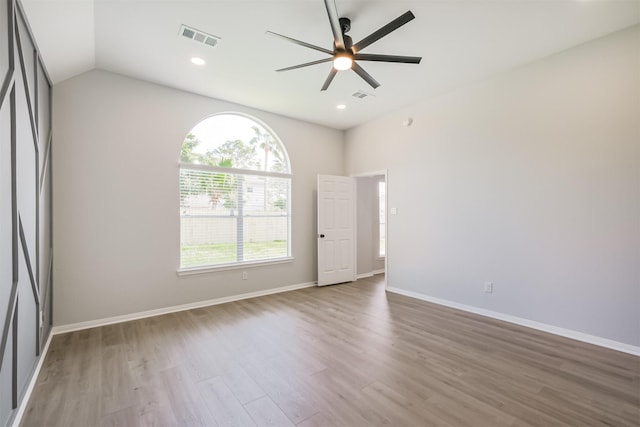 unfurnished room with hardwood / wood-style floors, ceiling fan, and vaulted ceiling