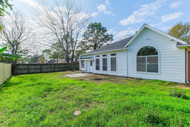 rear view of property with a yard