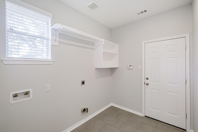 laundry room with hookup for an electric dryer, light tile patterned floors, and hookup for a washing machine