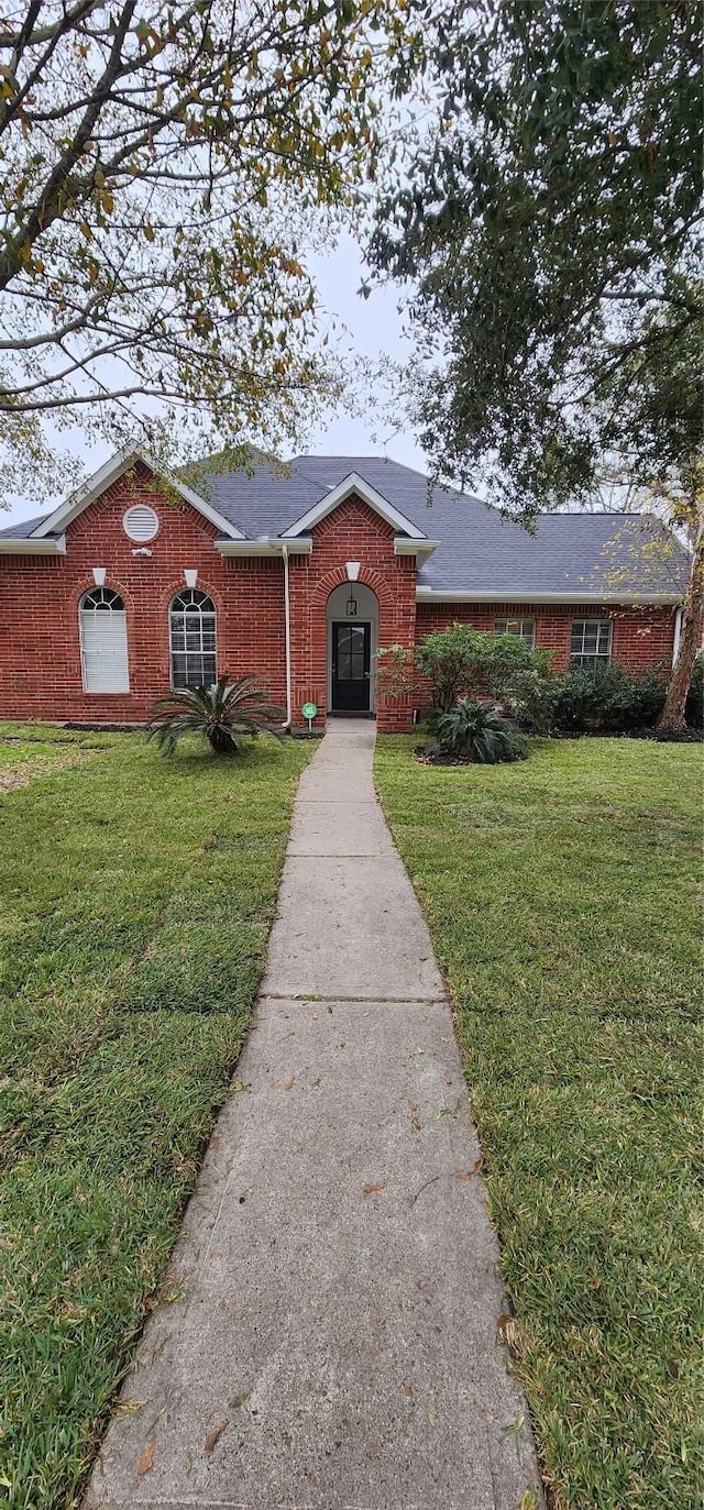 ranch-style house with a front lawn