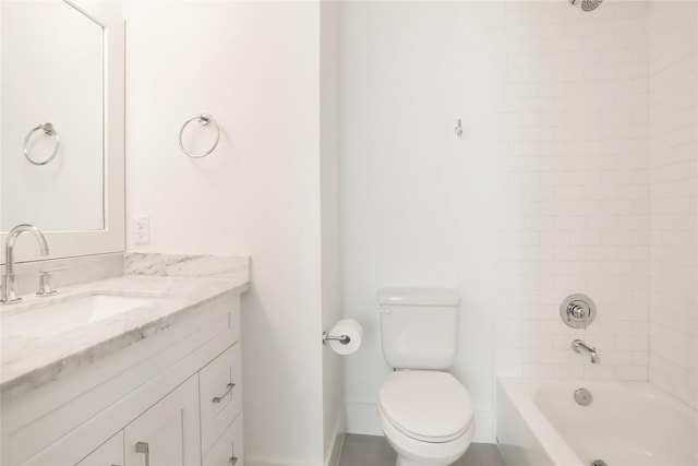 full bathroom featuring vanity, tiled shower / bath combo, and toilet