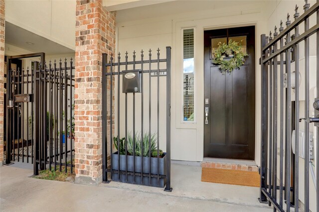 doorway to property featuring brick siding