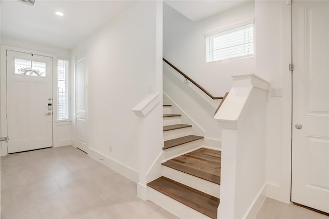 foyer with stairs, baseboards, and recessed lighting