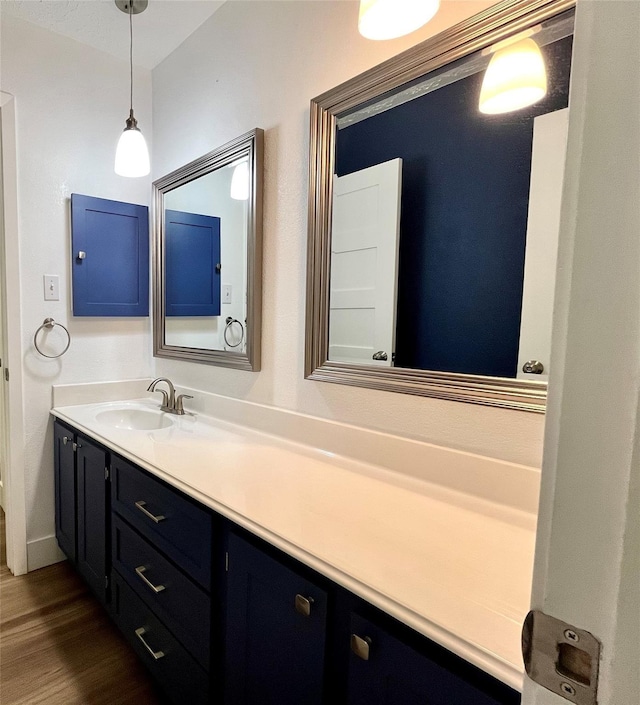 bathroom with vanity and hardwood / wood-style flooring