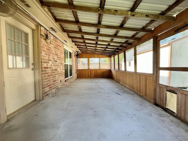 unfurnished sunroom featuring lofted ceiling