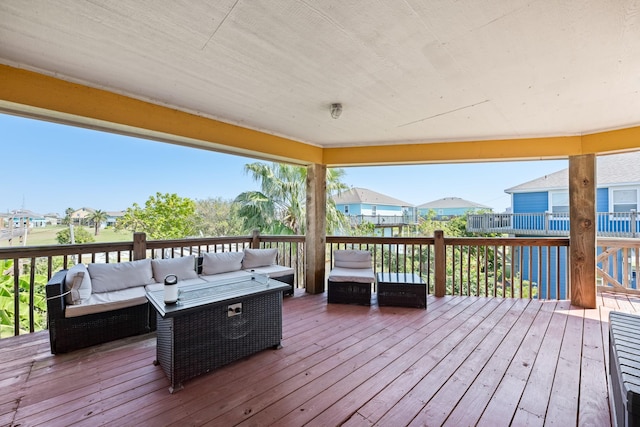 wooden deck with outdoor lounge area and a water view