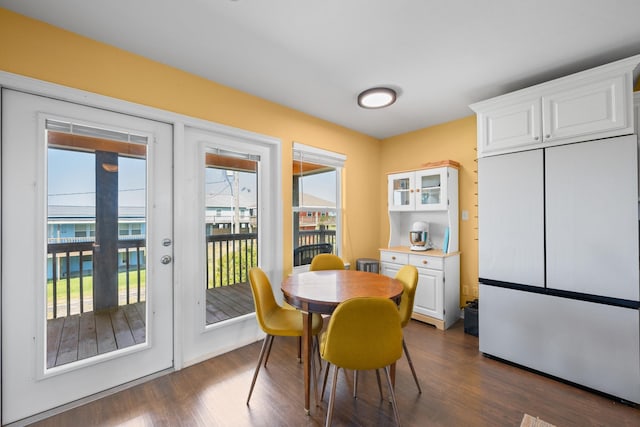 dining space with french doors and dark wood-type flooring