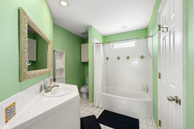 full bathroom featuring shower / bath combo with shower curtain, tile patterned flooring, vanity, and toilet