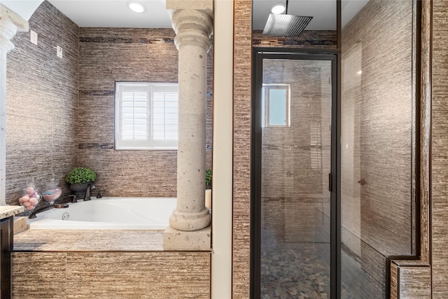 bathroom featuring decorative columns, vanity, and independent shower and bath