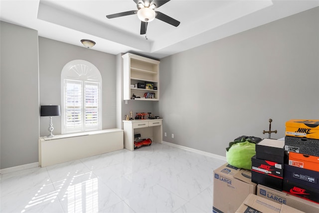 rec room with a raised ceiling and ceiling fan