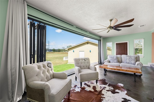 sunroom / solarium featuring ceiling fan