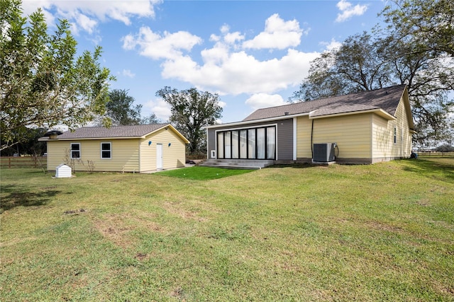 back of property with a lawn, central AC, and a sunroom