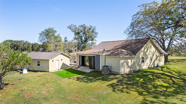 back of house with a lawn and central air condition unit