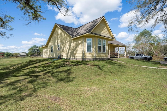 view of home's exterior featuring a porch and a yard