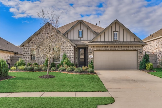 english style home with a garage and a front lawn