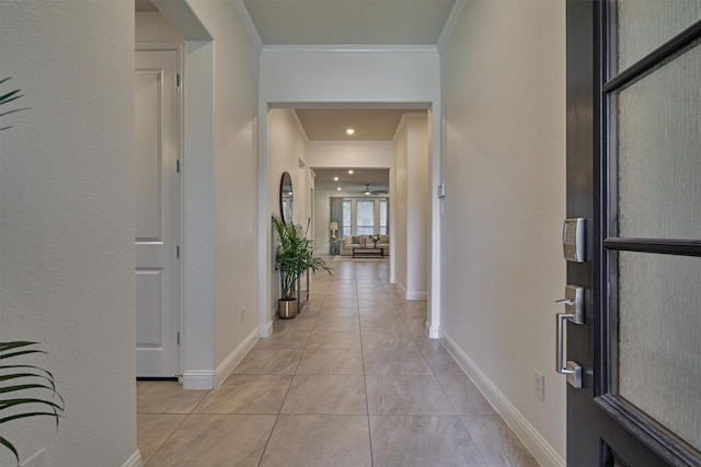 entryway featuring ceiling fan, crown molding, and light tile patterned flooring