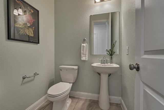 bathroom featuring toilet and tile patterned floors