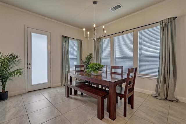 dining space with a notable chandelier, light tile patterned floors, and crown molding