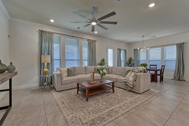 living room featuring plenty of natural light, light tile patterned flooring, and ceiling fan with notable chandelier