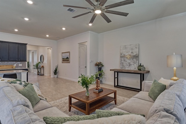 living room featuring ceiling fan, light tile patterned floors, and ornamental molding