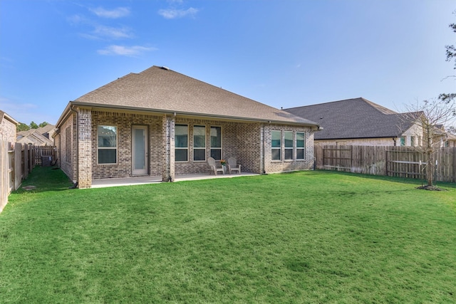 rear view of property featuring a patio area and a yard