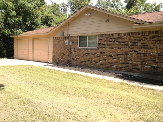 view of property exterior featuring a yard and a garage