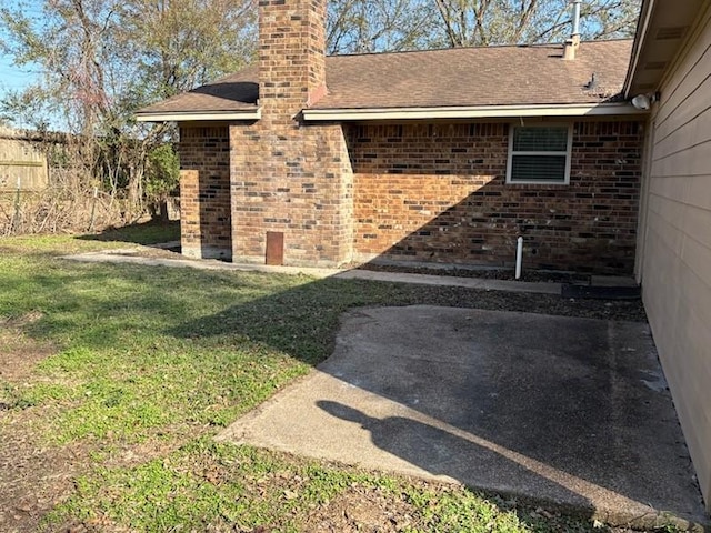 doorway to property with a patio area and a yard