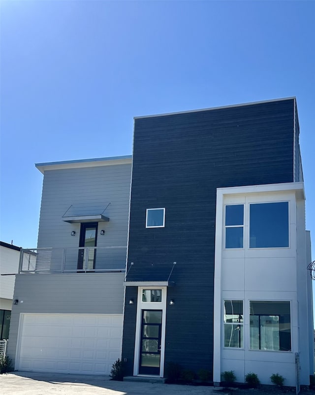 contemporary home featuring a balcony and a garage