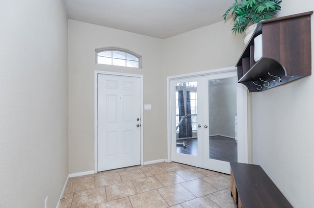 foyer entrance featuring light tile patterned floors and french doors