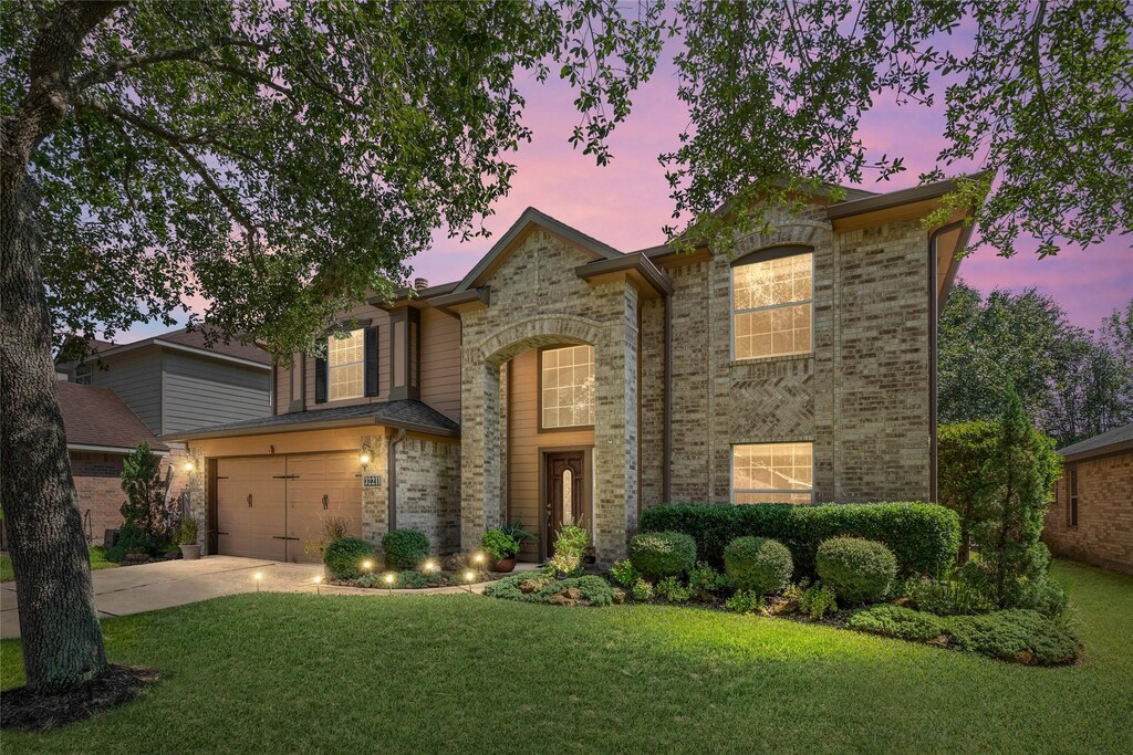 32211 Archer Park, Conroe, TX 77385 - view of front of house featuring a garage and a lawn