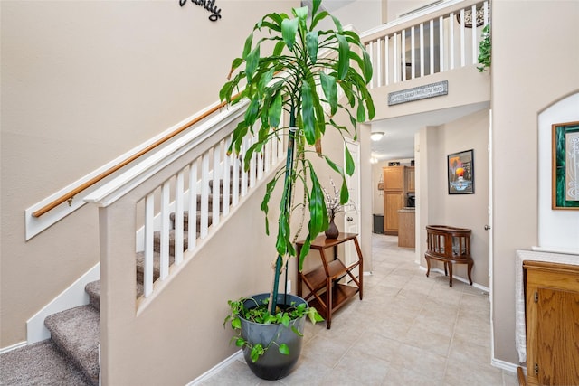 staircase featuring a high ceiling