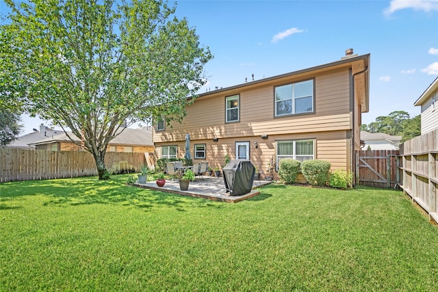 rear view of property with a patio area and a yard