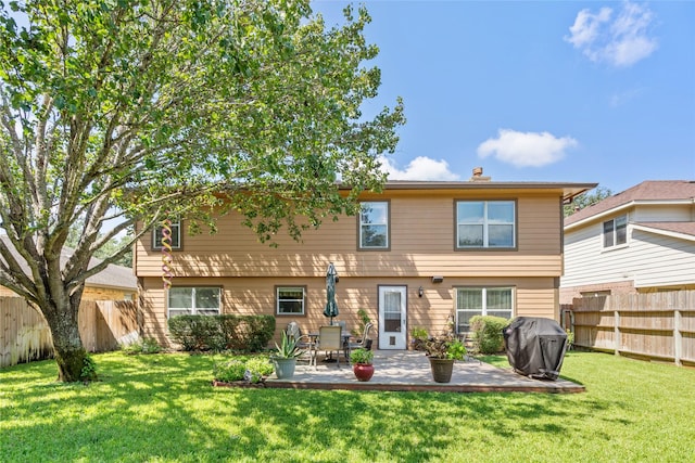 rear view of property featuring a patio area and a yard