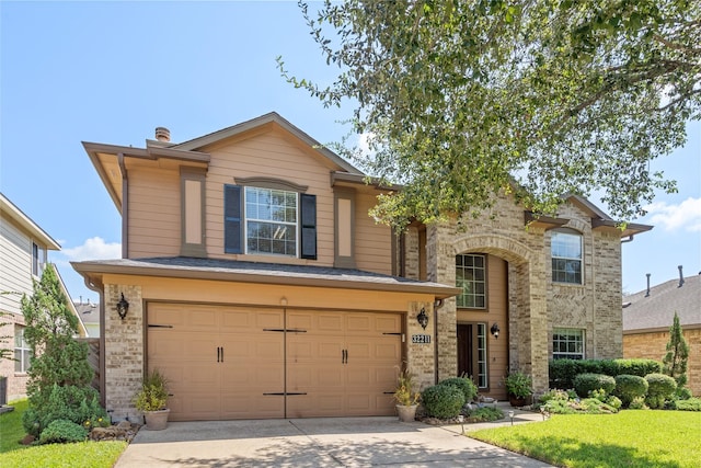 view of front of property with a garage and a front lawn