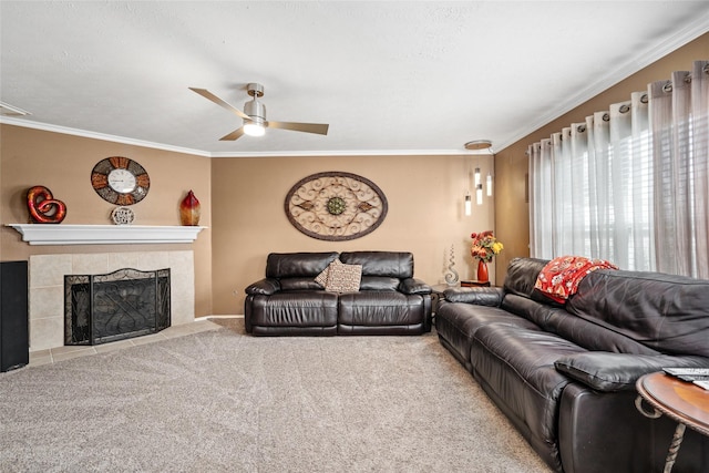 carpeted living room with a tile fireplace, ceiling fan, and crown molding